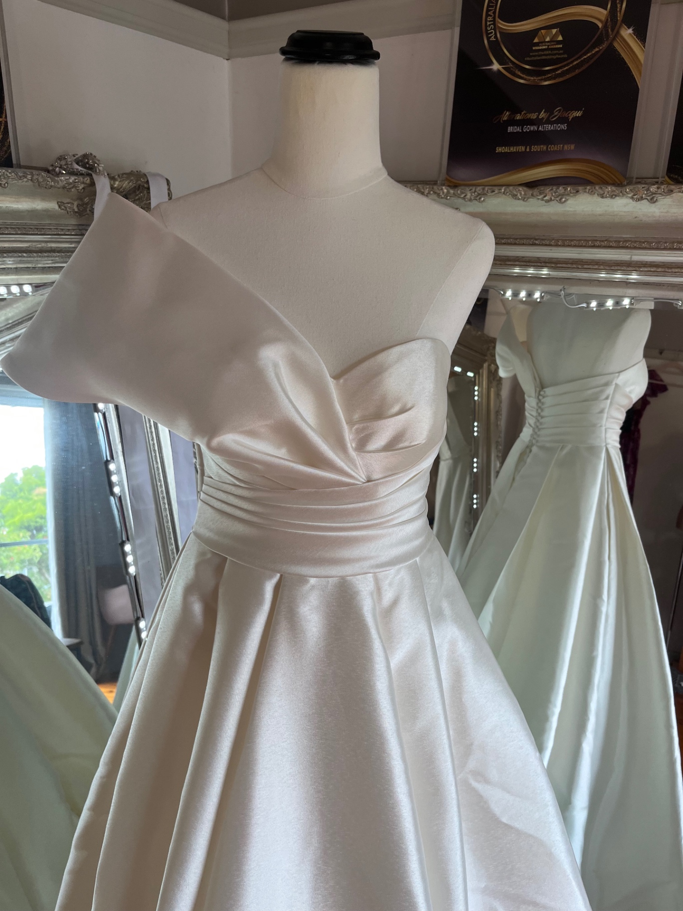 One-shoulder satin wedding gown with folded bodice and ruched waist fitted at Jacqui's Shoalhaven Heads studio