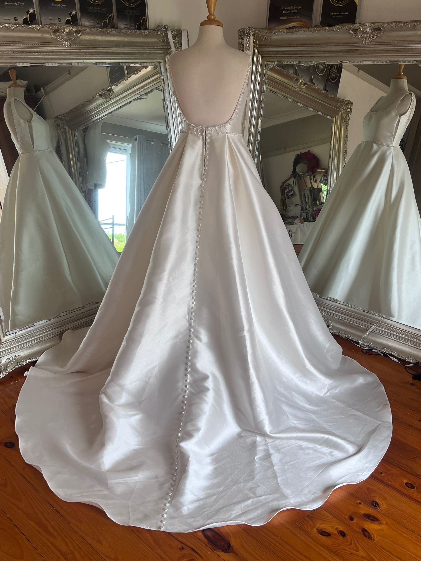 Satin A-line wedding gown with covered-button back and full train fitted at Jacqui's Shoalhaven Heads studio