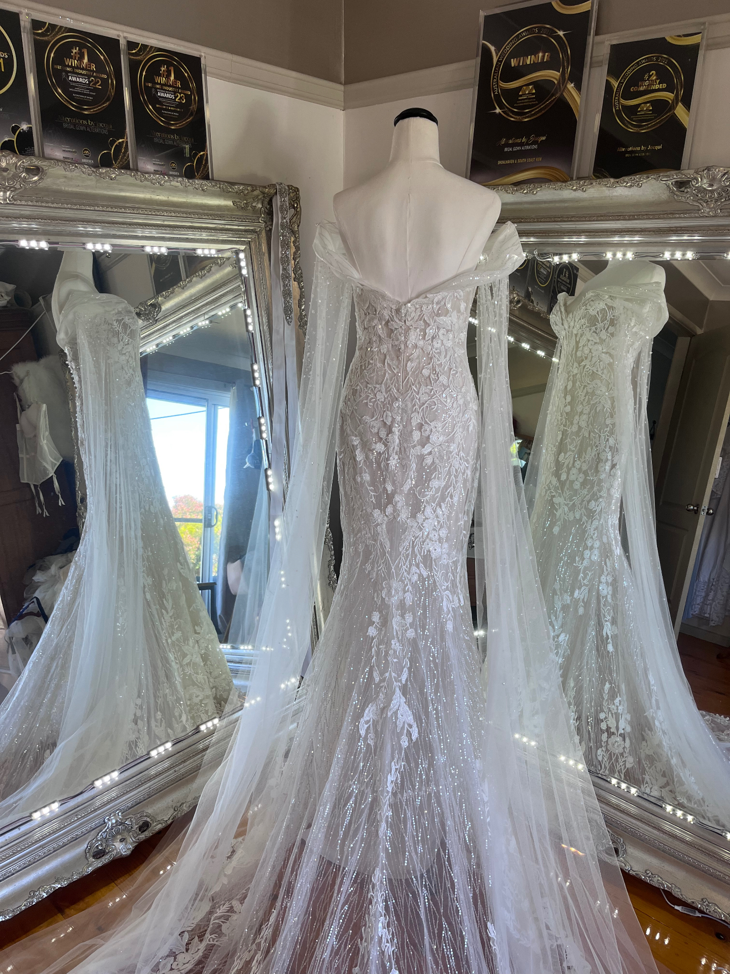 Off-shoulder beaded lace fit-and-flare gown with glitter tulle cape sleeves altered by Alterations by Jacqui