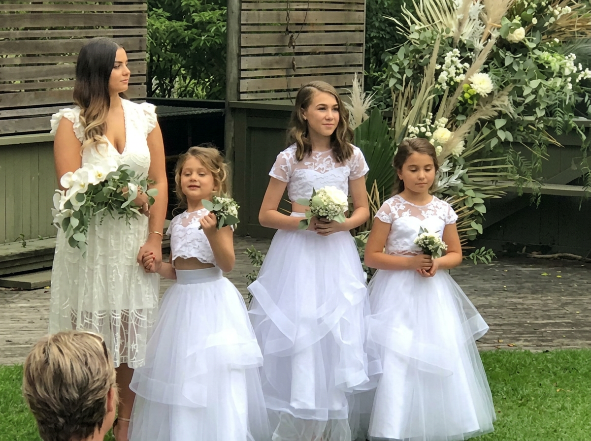 Flower girls in white two-piece tulle dresses at an outdoor wedding ceremony, NSW South Coast