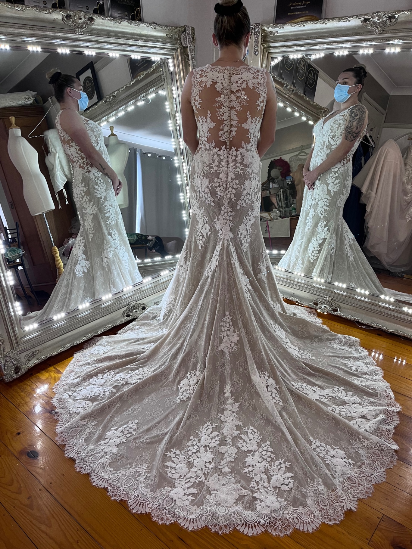 Fitted lace wedding gown with illusion back and long train after bespoke bridal alterations by Jacqui
