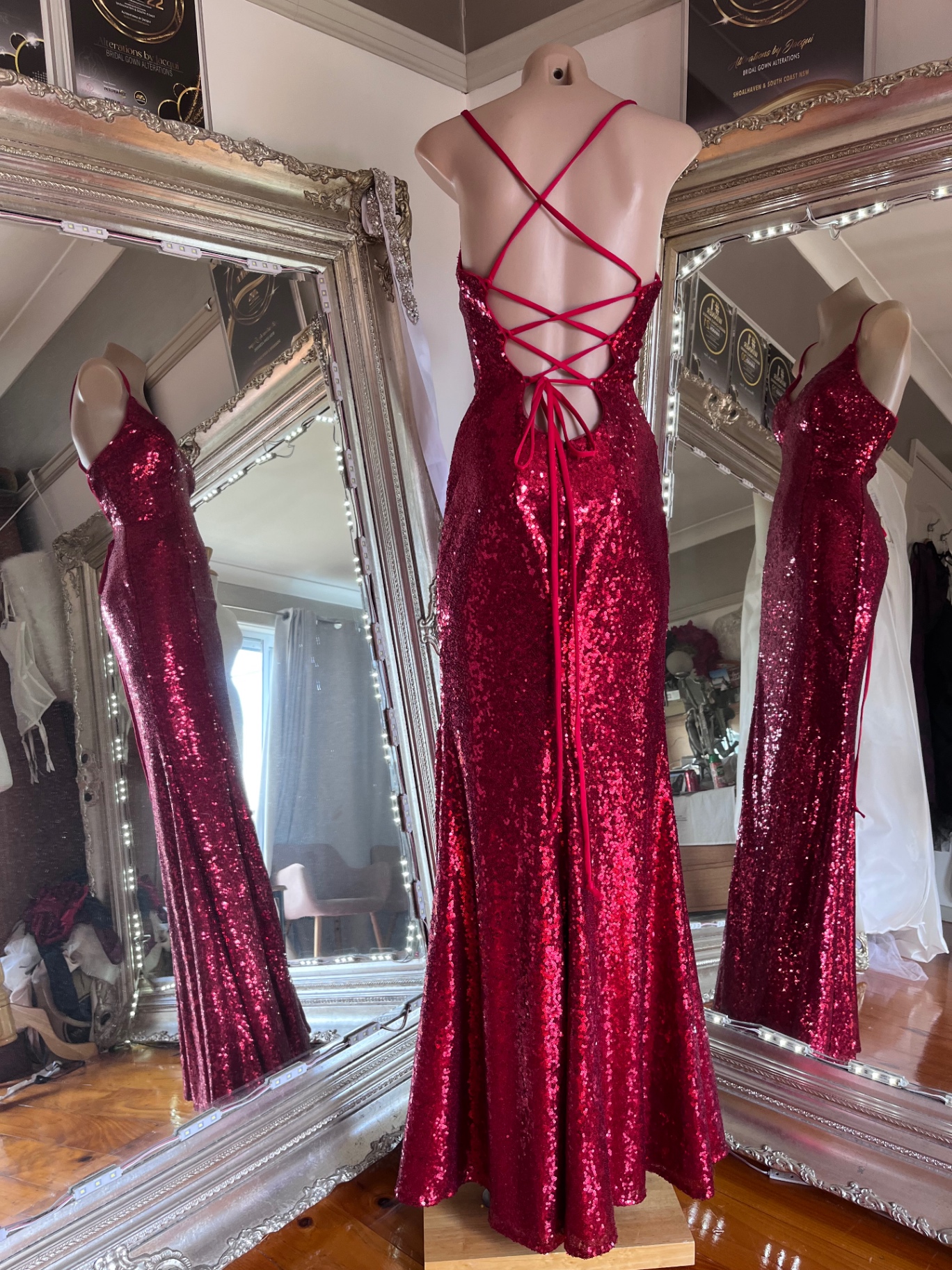 Red sequin formal gown with strappy lace-up back on a mannequin — formal gown alterations and lace-up back conversion by Jacqui, NSW South Coast