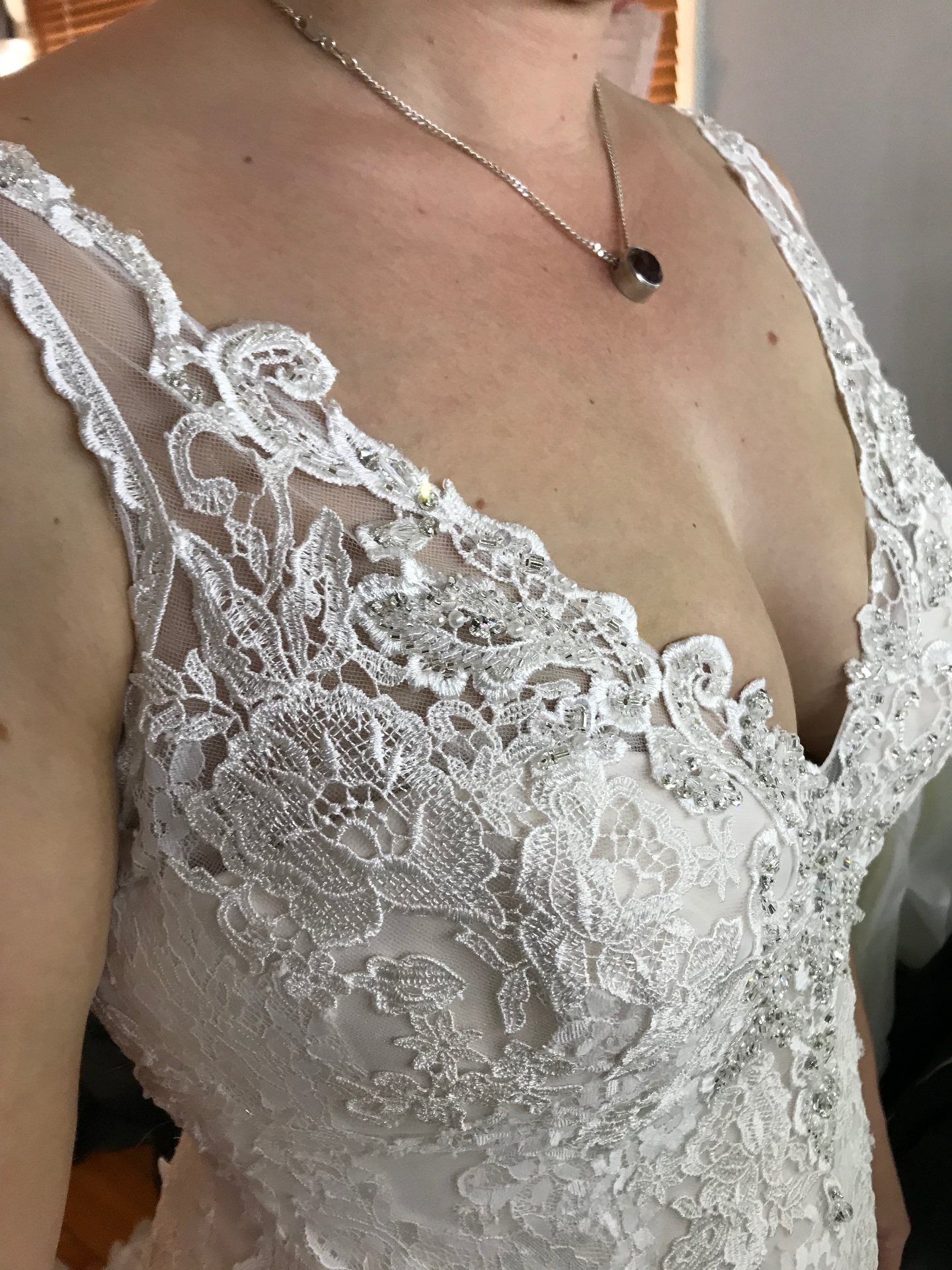 Beaded lace V-neck bodice detail on a fitted wedding gown altered on the NSW South Coast