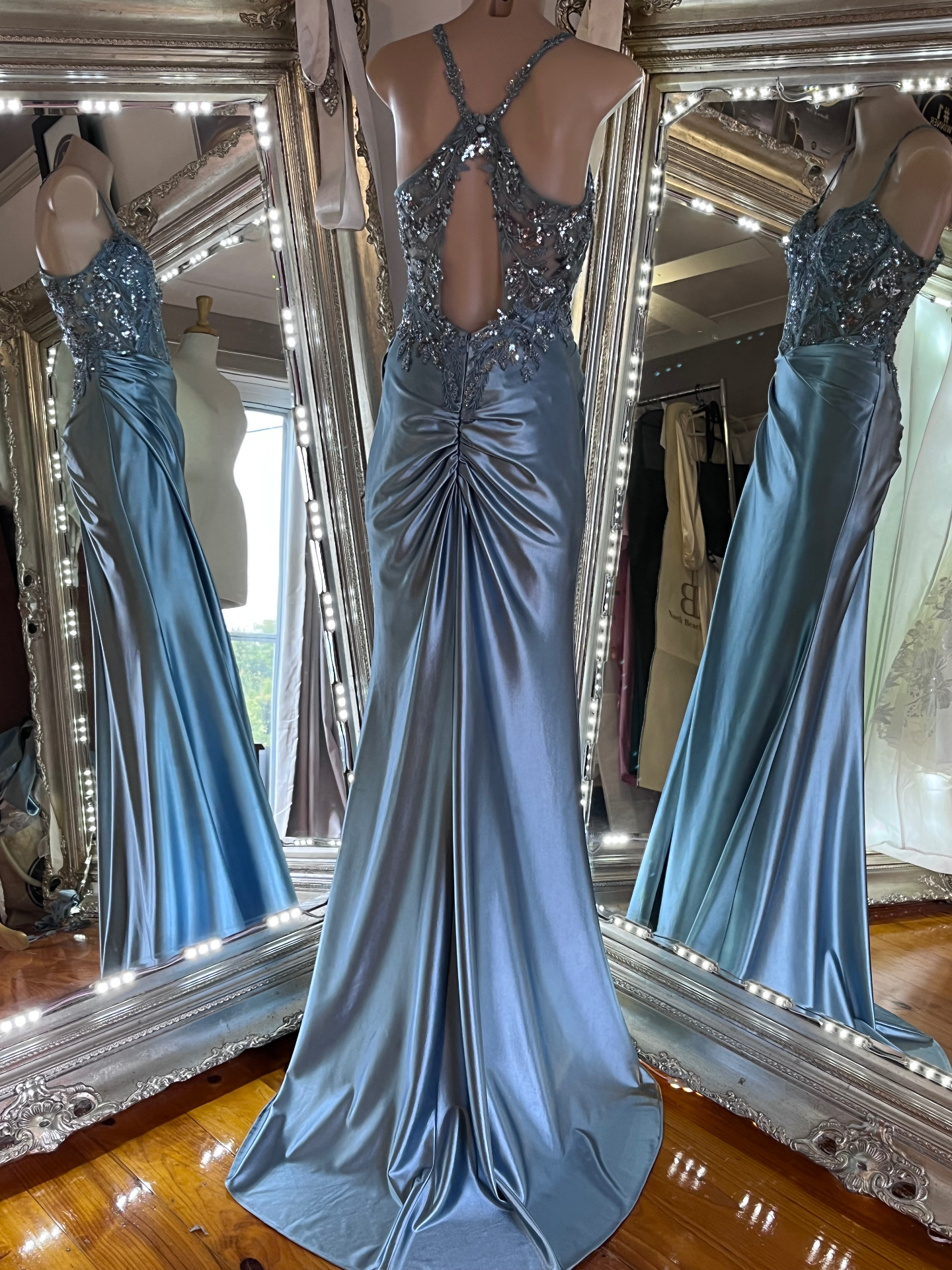 Steel blue satin formal gown with beaded sheer bodice and cut-out back on a mannequin — debutante and formal gown alterations by Jacqui, NSW South Coast